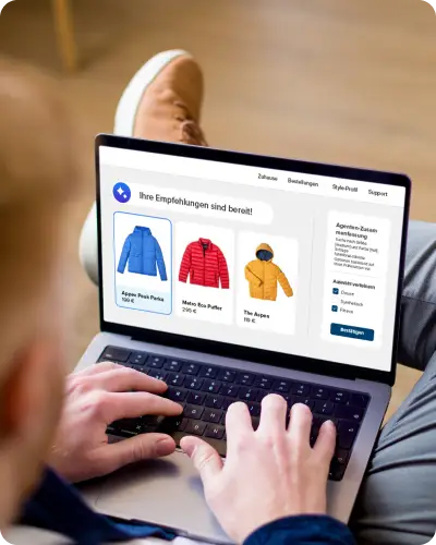 AI Apps & Agents 4 - DE (1) A professional holding a credit card while reviewing a chat interface on a laptop that displays AI-generated financial data and simulated user inquiries.