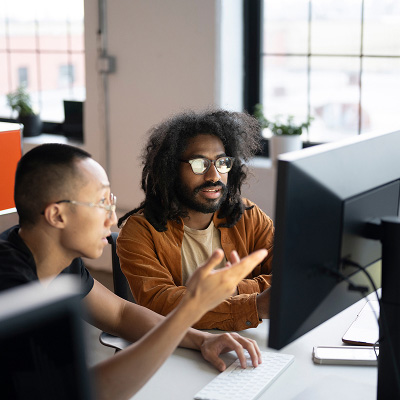 Benchmarking A QA team collaborating to analyze performance metrics and establish an AI quality baseline.