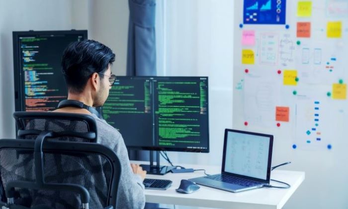 A four-member engineering team works around a desk