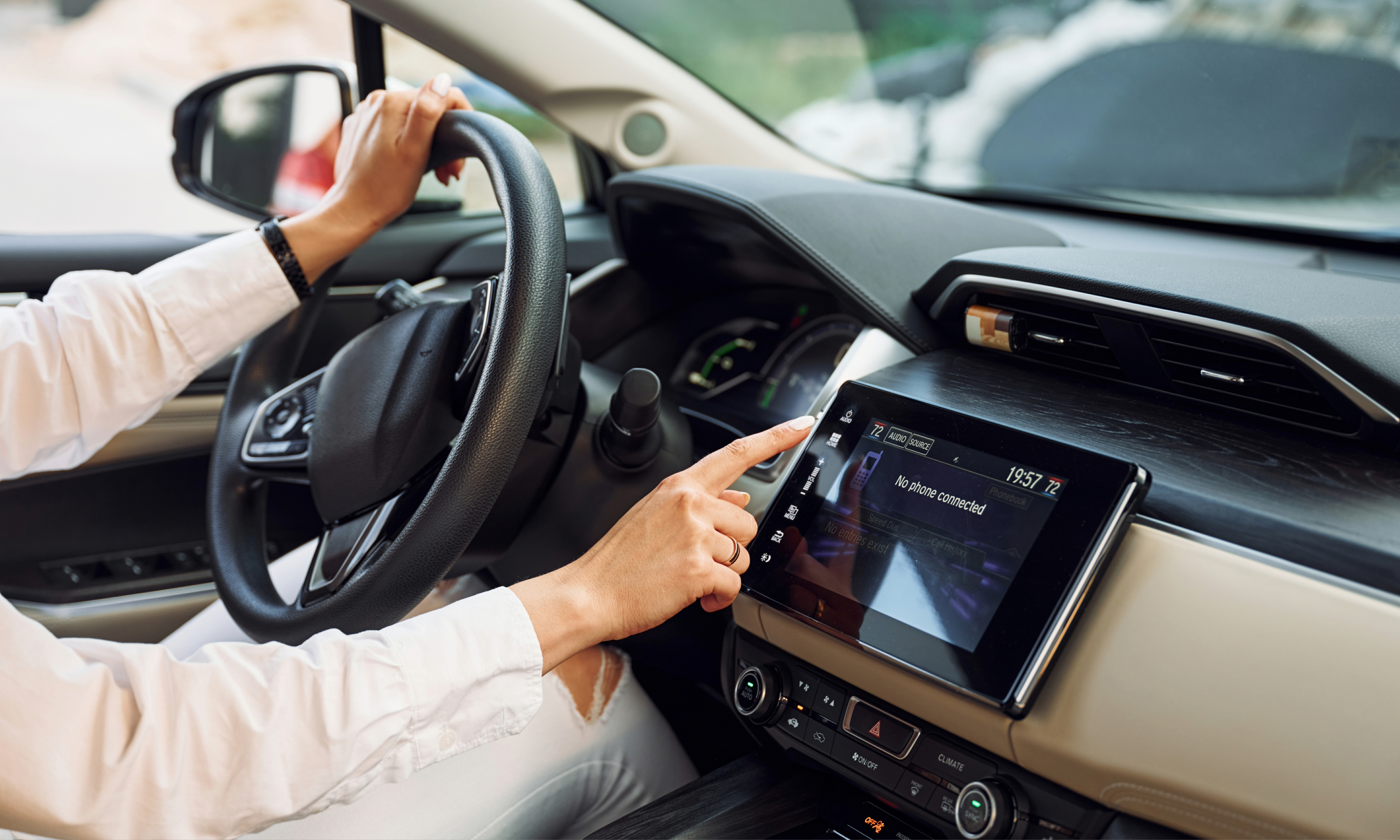 Driver using a car infotainment system.
