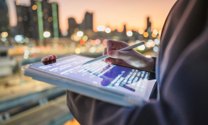 MKT-6659-AI-webinar-blog close up of tablet with code for AI application