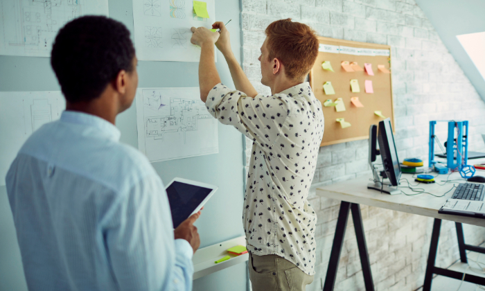 Two software developers creating a user-centric testing plan.