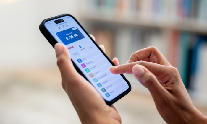 Woman using a mobile banking app to check spending