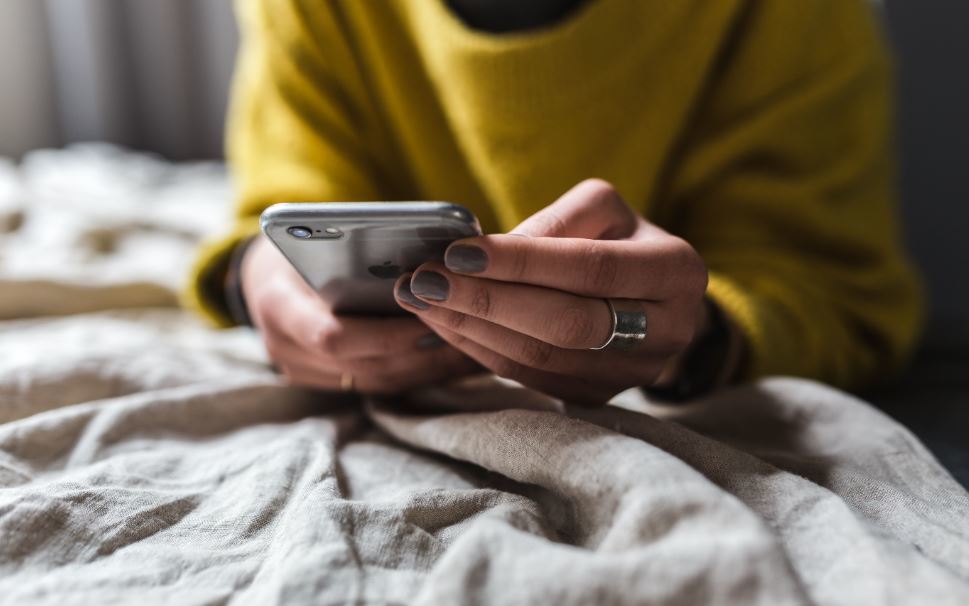 A woman interacts with a mobile phone app..