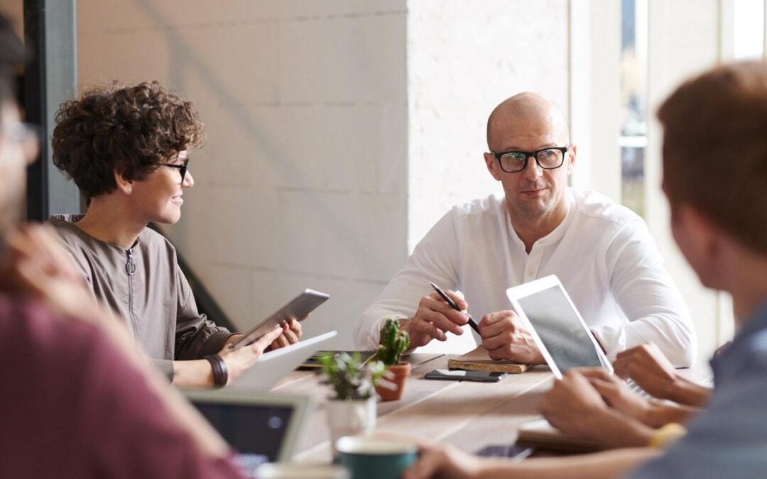 Software engineers collaborate around a table.