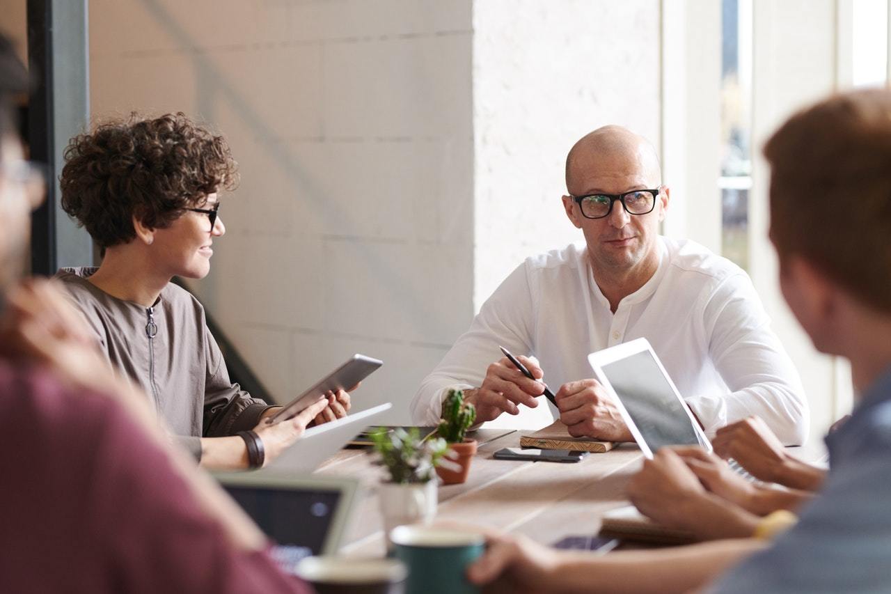 Software engineers collaborate around a table.